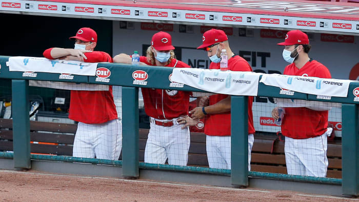 Reds players wearing masks in the dugout